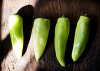 Aerial view of fresh jalapeno pepper on wooden background