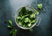 Natural organic fresh spinach in a sieve