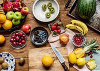 Aerial view of various fresh organic fruits on wooden table