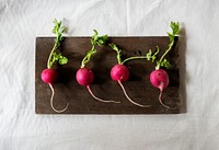 Closeup of fresh radish on wooden background