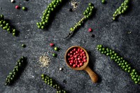 Aerial view of fresh peppercorns on black background