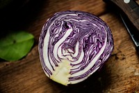 Closeup of fresh cut organic red cabbage on wooden table
