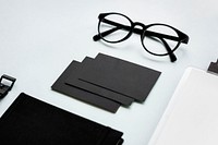 Closeup of black paper cards with eyeglasses on table