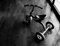 Kid bicycle on the wooden floor grayscale