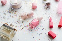 Cosmetic objects and confetti isolated on background
