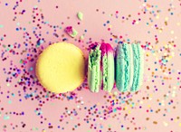 Macaron with confetti and pink background