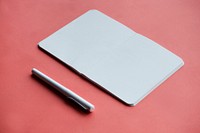 Blank notebookand pen isolated on background