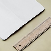 Blank notebook and ruler isolated on background