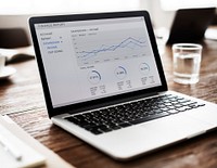 Laptop with business graphs and charts