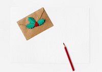 Christmas envelope and a red pencil