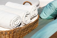 Hotel Towels Rolled in Wooden Basket