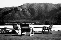 Empty Chairs on Grass Field Among Mountains Nature