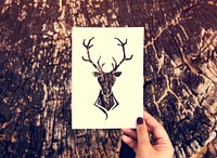 Hand Hold Deer with Antlers Paper Carving with Nature Background