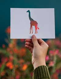 Hand Hold Giraffe Paper Carving with Flower Background