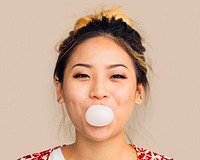 Woman blowing bubblegum, cheerful face portrait psd