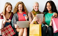 A group of diverse women is shopping online