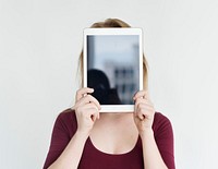 Person holding tablet in front of face
