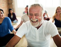 Happy senior man in a yoga class<br />