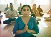People concentrating to meditate while sitting