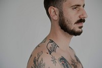 Serious facial expression naked tattooed man