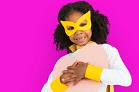 Curly haired cute girl hugging a pink heart paper prop