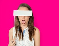 Young woman with her tongue out holding a blank paper flag