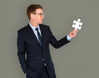 Businessman holding a puzzle piece