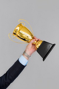 Human Hand Holding Trophy Reward Success