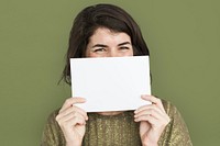 Woman holding a blank piece of paper to her nose and mouth