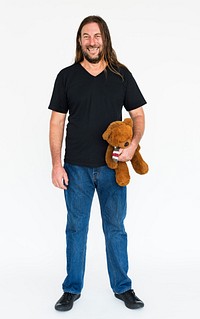 Mature long haired guy holding a teddy bear