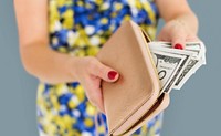 Close up of woman's hands taking money out of the purse