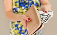 Close up of woman&#39;s hands taking money out of the purse