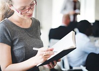 Closeup of caucasian woman writing on notepad