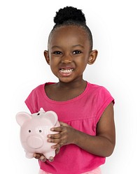 Cute little girl smiling awkwardly holding a piggy bank