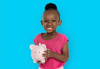 Cute little girl smiling awkwardly holding a piggy bank