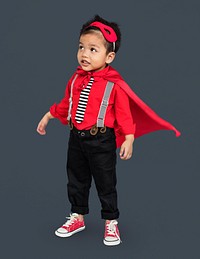 Full body portrait of a little boy in a casual superhero costume