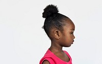 Profile portrait of a cute little girl with a bun
