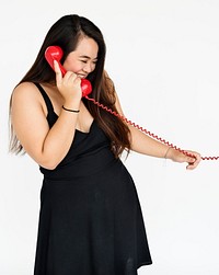 Studio portrait of a young asian woman on the phone