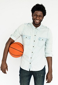 Studio portrait of a young man with a basketball