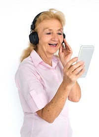 Studio portrait of a senior lady listening to music on her mobile