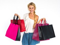 Studio portrait of a blonde woman with shopping bags