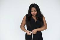 Studio portrait of a sad woman measuring her waist