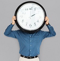 Man Holding Clock Covering Face