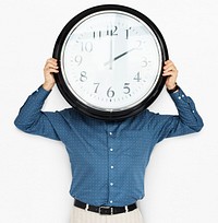 Man Holding Clock Covering Face