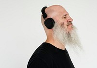 Portrait of a big bearded man listening to music