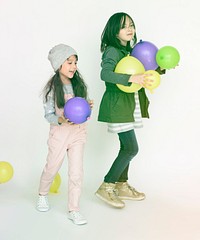 Young kids playing with balloon