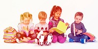 Group of little kids sitying and reading the book together