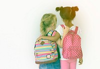 LIttle girls friends rear view with bag to go to school