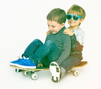 Little boys friends palying skateboard have fun together