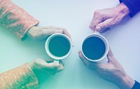 People hands holding coffee cup in aerial view
